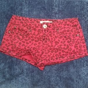 Red with black animal print shorts.
